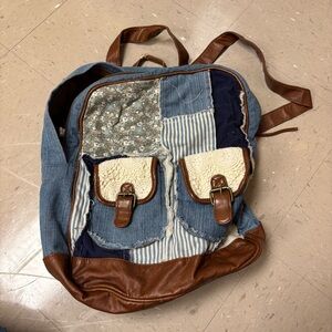 Blue patchwork backpack with leather trim and gold hardware